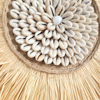 Seashell & Raffia & feathers juju hat Wall Decor - Boho close-up featuring natural seashell textures.