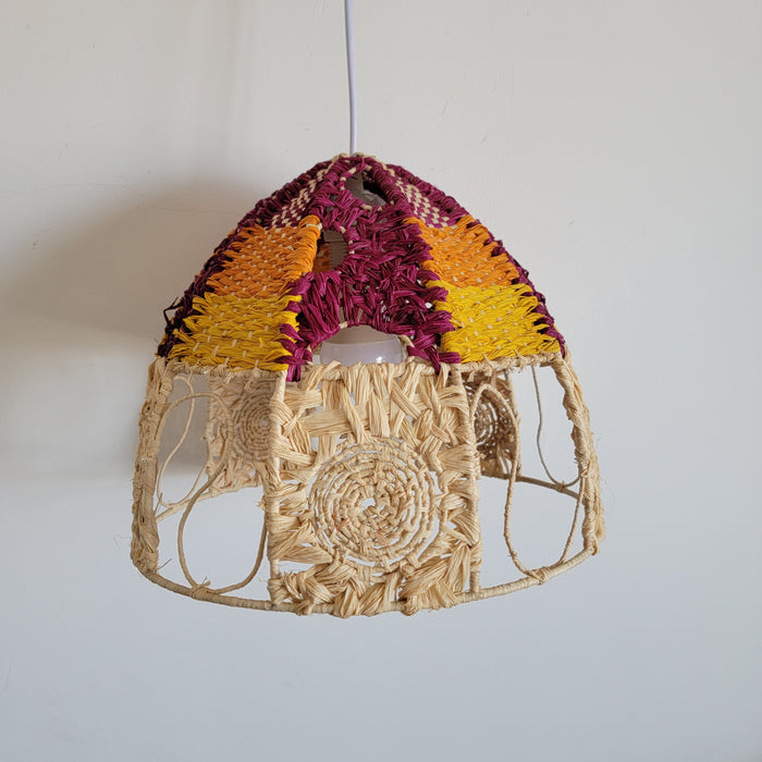 Handwoven raffia lamp shade featuring colorful patterns in a boho chic design, perfect for unique lighting decor.
