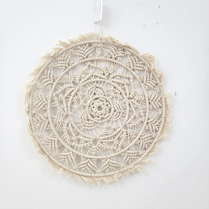 Handmade circular bohemian macrame wall hanging showcasing intricate patterns and delicate fringes, perfect for home decor.