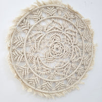 Handmade circular bohemian macrame wall hanging showcasing intricate patterns and delicate fringes, perfect for home decor.