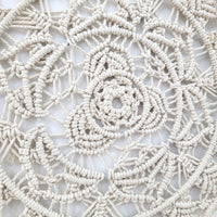 Handmade circular bohemian macrame wall hanging showcasing intricate patterns and delicate fringes, perfect for home decor.