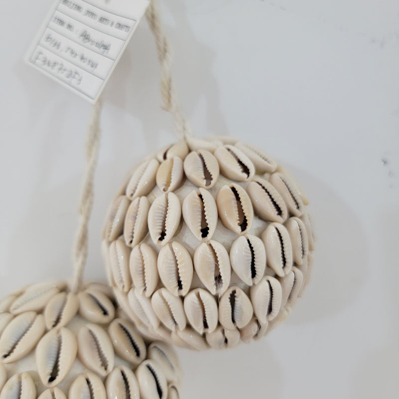 Handcrafted BOHO sea shell ball ornament, perfect for Christmas décor, showcasing intricate shell details.