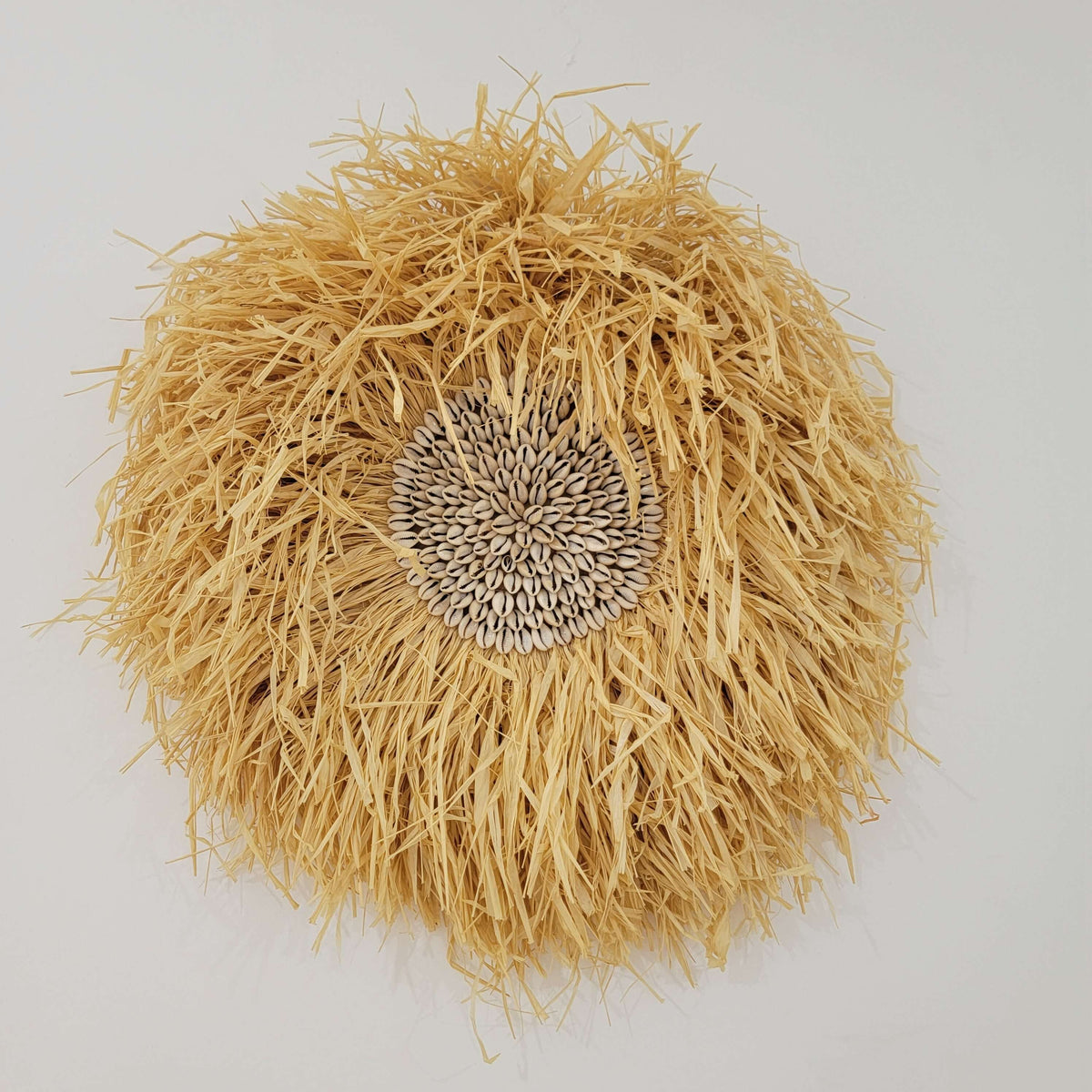 Seashell & Raffia juju hat Wall Decor - Boho, handmade rustic straw wall art with sunflower seed cluster and natural fibers.