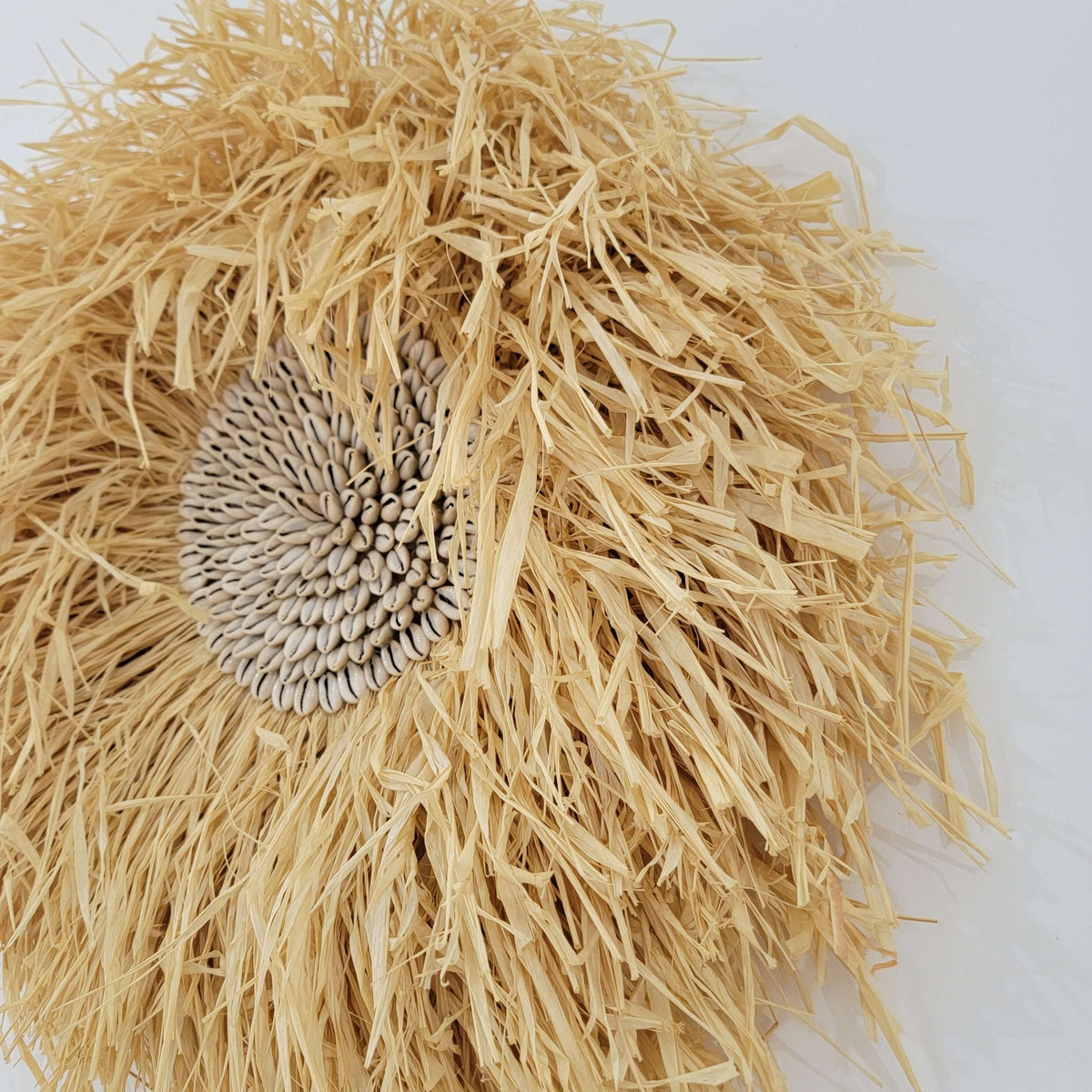 Seashell & Raffia juju hat Wall Decor - Boho showcasing rustic straw fibers and a sunflower seed cluster.