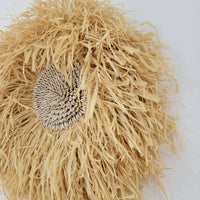 Seashell & Raffia juju hat Wall Decor - Boho showcasing rustic straw fibers and a sunflower seed cluster.