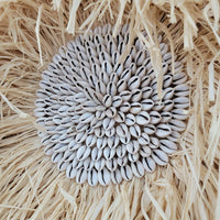 Seashell & Raffia juju hat Wall Decor - Boho close-up showcasing sunflower seed cluster and natural straw fibers.