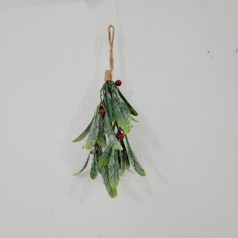 Artificial Christmas mistletoe hanging decoration with red berries and hemp rope.