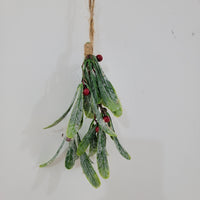 Artificial Christmas mistletoe hanging decoration with red berries and hemp rope.