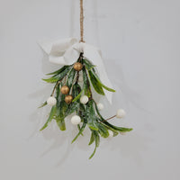 Artificial mistletoe decoration with green leaves and white, gold berries, tied with a ribbon, perfect for holiday decor.
