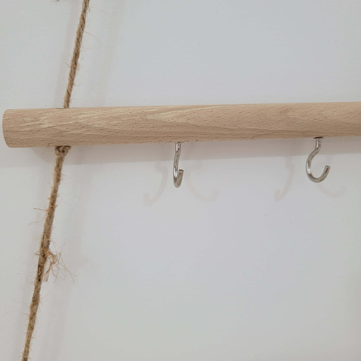 Rustic wooden christmas tree wall mounted hook rack featuring metal hooks and jute rope for a charming decor accent.