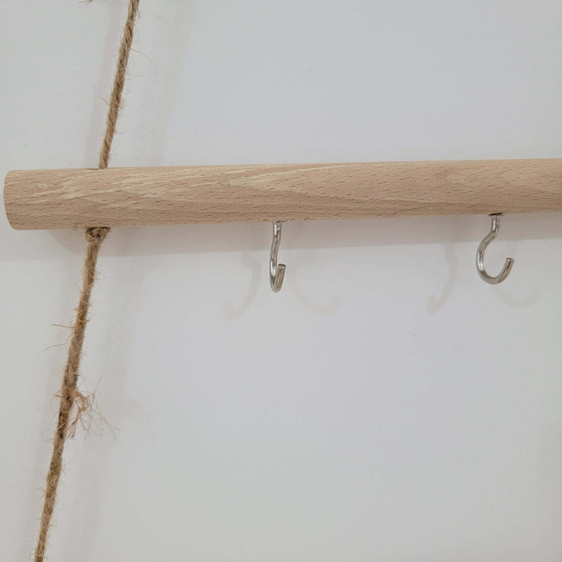 Rustic wooden christmas tree wall mounted hook rack featuring metal hooks and jute rope for a charming decor accent.