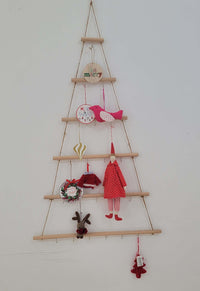 Rustic wooden christmas tree wall mounted hook rack with decorative ornaments and handcrafted details.
