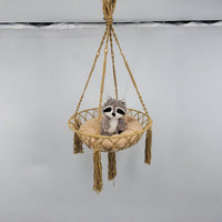 macrame cat hammock with a plush raccoon toy resting on a soft cushion, perfect for cat lover gifts.