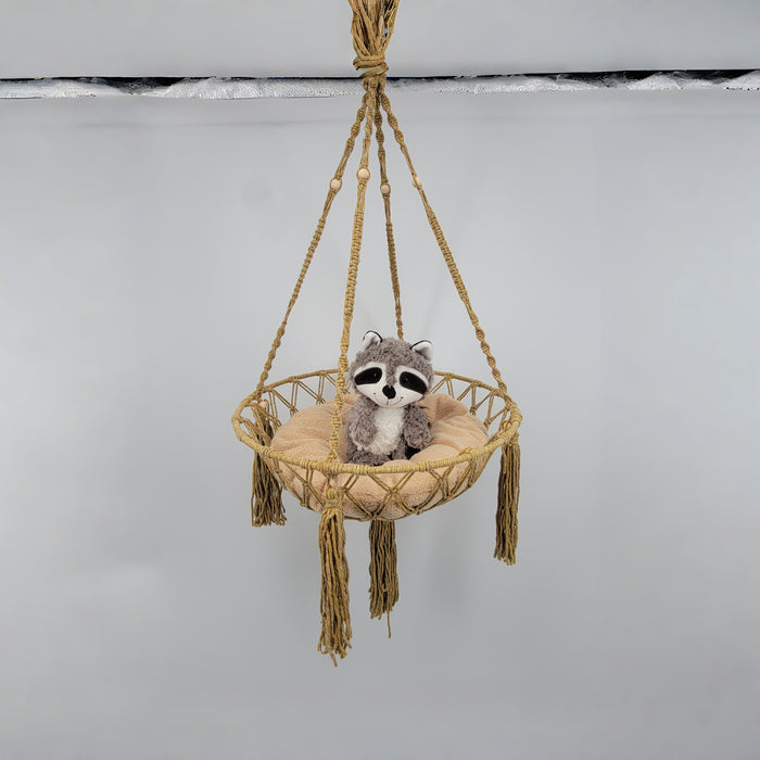 macrame cat hammock with a plush raccoon toy resting on a soft cushion, perfect for cat lover gifts.